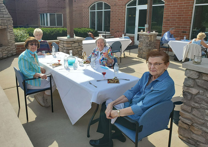 Residents at table on patio